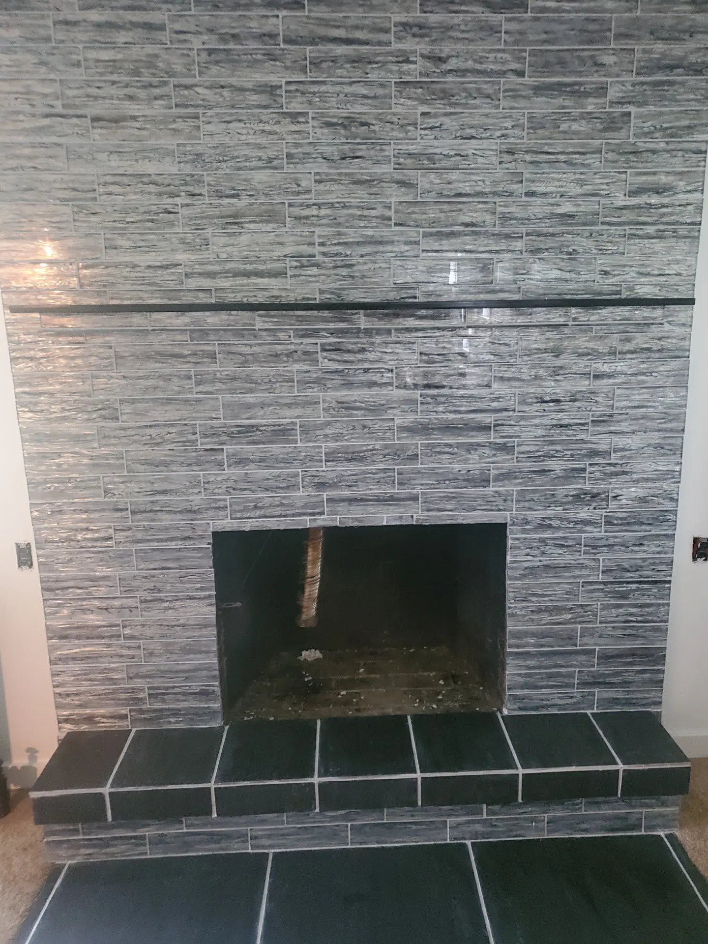 Glass tile fireplace surround